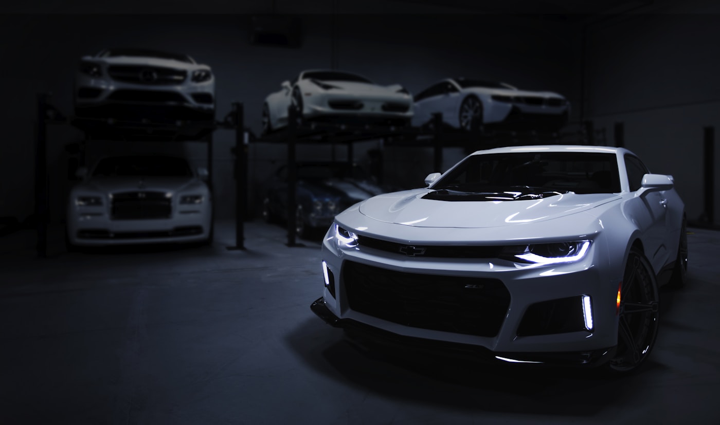 Finished performance vehicle under dramatic detailing lights